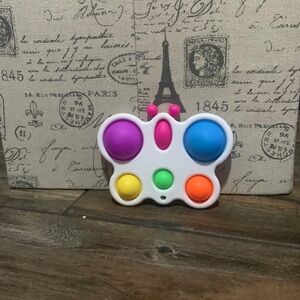 A pink,purple,yellow,green and orange butterfly pop it